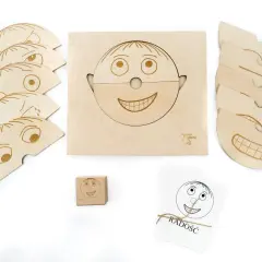 Drewniane pomoce dydaktyczne do nauki emocji: puzzle twarzy, kostka i karty z buźkami.